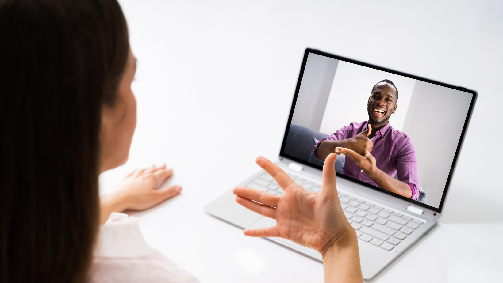 Woman having a video call with a man, presumably an American sign language, ASL